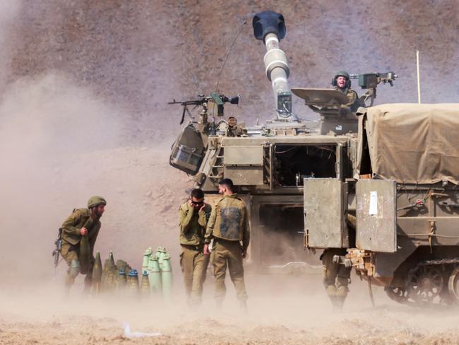 EDITORS NOTE: Graphic content / TOPSHOT - An Israeli army self-propelled howitzer fires rounds near the border with Gaza in southern Israel on October 11, 2023. Israel declared war on Hamas on October 8 following a shock land, air, and sea assault by the Gaza-based militant group. The death toll in Israel has surged above 1,000 following the worst attack in the country's 75-year history, while Gaza officials have reported 900 people killed so far. (Photo by Menahem KAHANA / AFP)