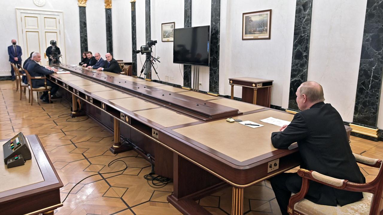 The desk of a man who is definitely not compensating for his teeny tiny ... economy. Picture: Alexey Nikolsky/Sputnik/AFP