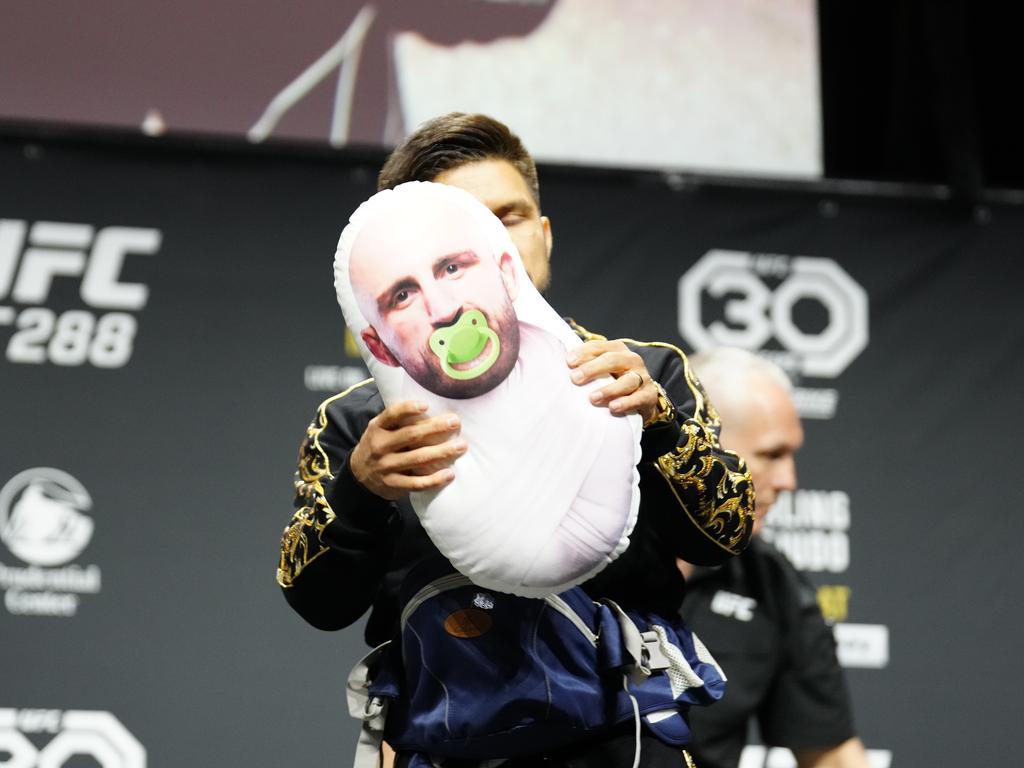 Henry Cejudo holding a doll with Volkanovski’s face on it last year. Picture: Louis Grasse/PxImages/Icon Sportswire via Getty Images