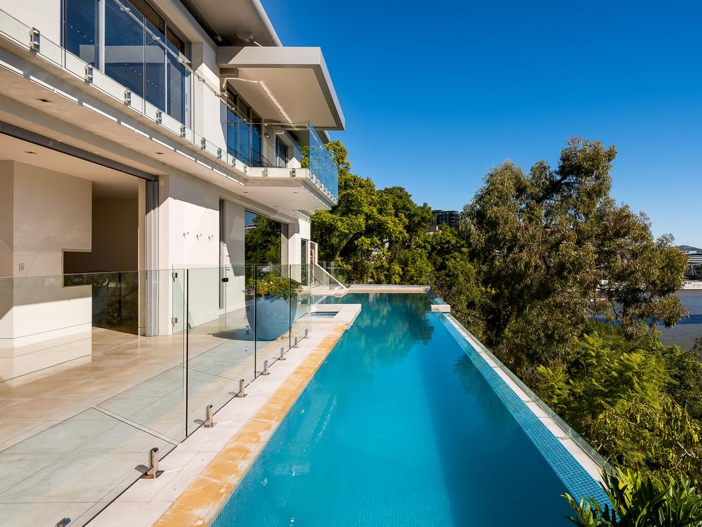 The infinity lap pool and spa runs along the cliff edge.