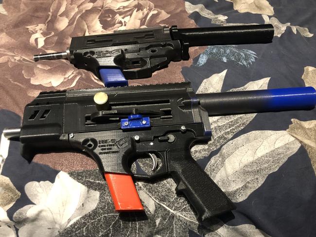 The completed 3D-printed semiautomatic pistol and a partially built version that was also seized. Because the guns are predominantly made of polymer plastics, they could be harder to detect by security screening equipment. Picture: SAPOL