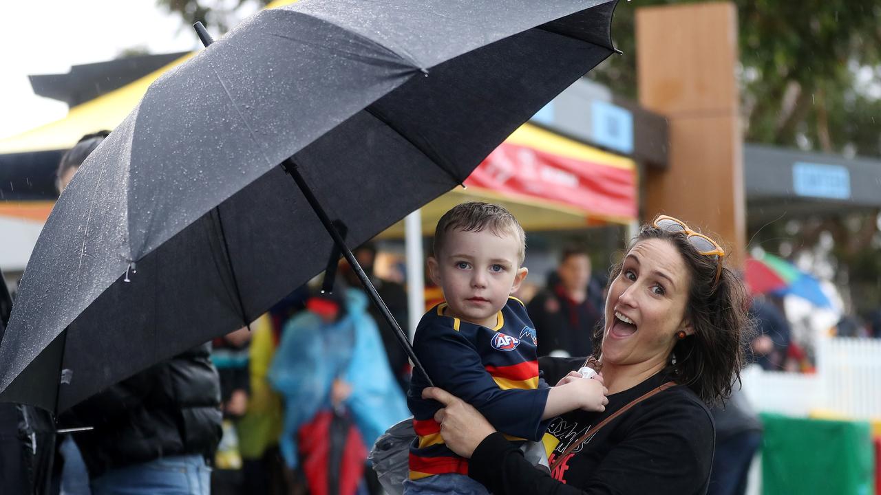 Fans try to find cover at Adelaide’s semi-final against Collingwood.