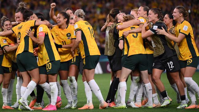 Australian players celebrate at the end of the Australia and New Zealand 2023 Women's World Cup quarter-final football match between Australia and France at Brisbane Stadium in Brisbane on August 12, 2023. (Photo by FRANCK FIFE / AFP)