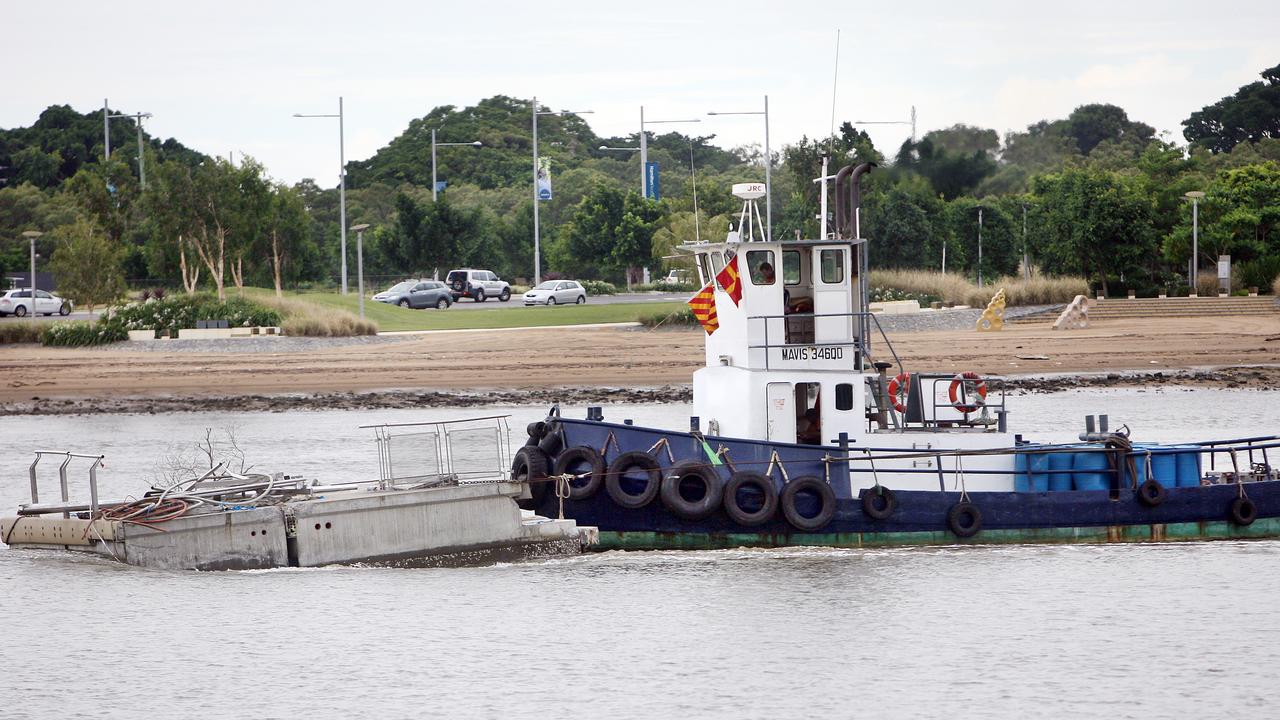 Hero tugboat captain Doug Hislop tows a section of the Riverwalk in March 2011.