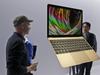 FILE - In this March 9, 2015 file photo, members of the media and Apple guests get a look at the new MacBook in the demo room after an Apple event in San Francisco. The company will debut the new laptop on Friday, April 10, 2015. (AP Photo/Eric Risberg, File)