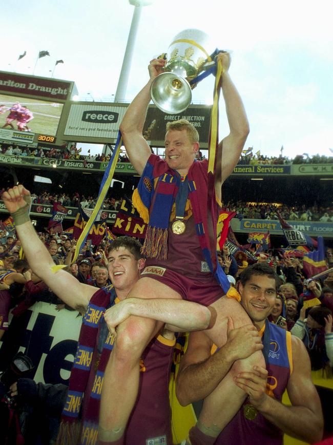 Footballer Michael Voss with Jonathan Brown, Mal Michael and premiership cup trophy.AFL football - Brisbane Lions vs Collingwood grand final match at the MCG 28 Sep 2002./Football/AFL