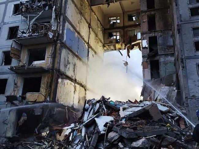 Rescuers extinguishing a fire in a residential building damaged after a strike in Zaporizhzhia. Picture: Handout / Ukrainian State Emergency Service / AFP