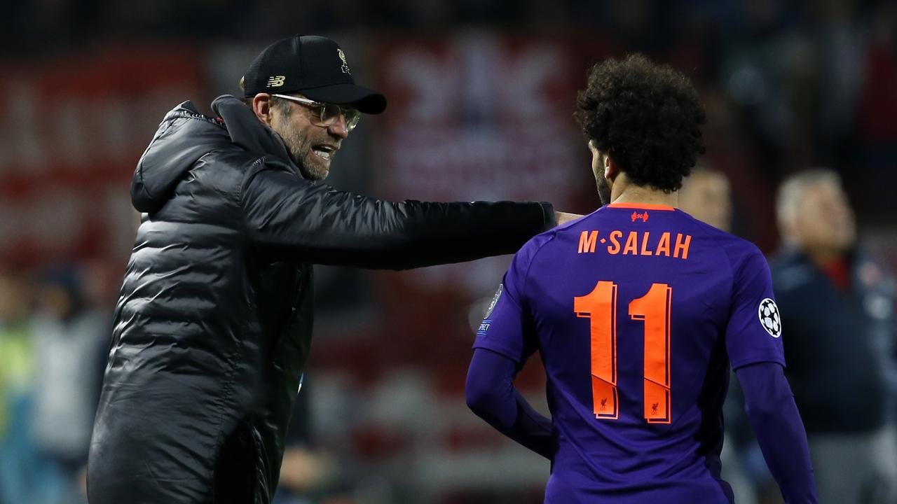 Liverpool coach Juergen Klopp, left, gives instructions to Mohamed Salah. Picture: AP Photo