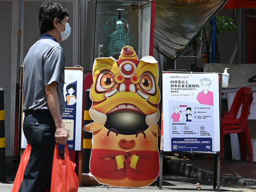 A man walks past a notification board with information on vaccinations in Singapore. Picture: AFP