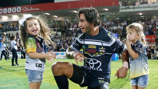 Johnathan Thurston, Co-Captain of the Cowboys enters the field for his 271st game for the Cowboys with his daughters Frankie (left) and Charlie during the Round 1 NRL match between the North Queensland Cowboys and the Cronulla-Sutherland Sharks at 1300 SMILES Stadium in Townsville, Friday, March 9, 2018. (AAP Image/Michael Chambers) NO ARCHIVING, EDITORIAL USE ONLY