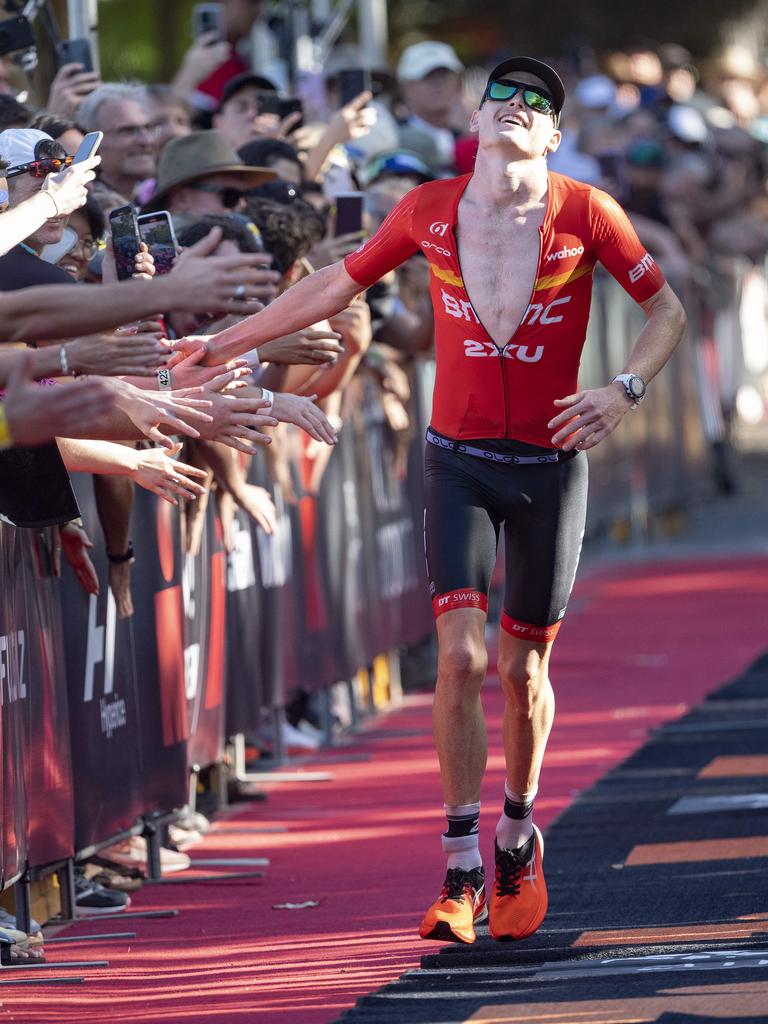 Cairns Iron Man - Winner Max Neumann ecstatic as he crosses the finish line in a new record time. Picture: Brian Cassey