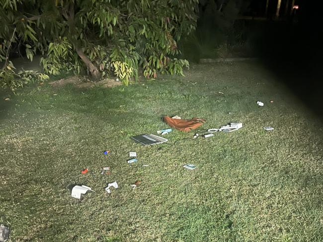 Upon returning home, the woman noticed her belongings strewn across the front yard, including her laptop.