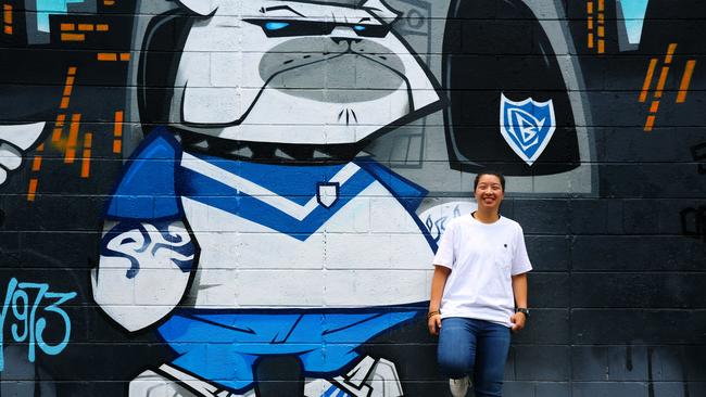 Alice Tauv next to a painting of the Bulldogs mascot in Lilian Lane. Picture: Angelo Velardo