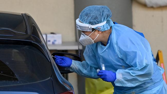 Health workers dressed in Personal Protection Equipment (PPE) conduct COVID-19 testing. Picture: NCA NewsWire/Bianca De Marchi