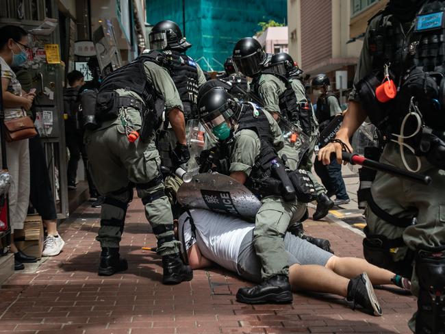 A man is detained by riot police during a demonstration in Hong Kong. Picture: Getty