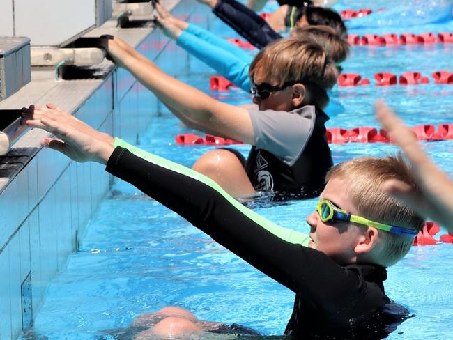 And they're off in the backstroke at the St Augustine's Primary School swimming carnival in Mossman.