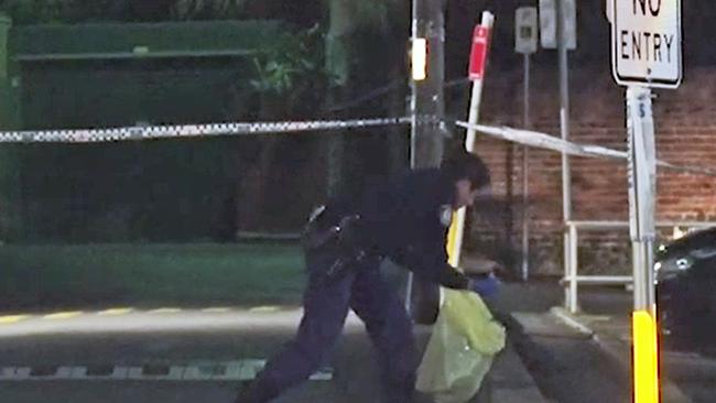 Police collecting evidence following the stabbing outside Woolworths. Picture: Seven News