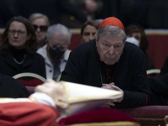 epa10387027 Australian Cardinal George Pell prays near the body of the late Pope Emeritus Benedict XVI (Joseph Ratzinger) lying in state in the Saint Peter Basilica for public viewing, Vatican City, 03 January 2023. Former Pope Benedict XVI died on 31 December 2022 at his Vatican residence, at the age 95. For three days, starting from 02 January, the body will lay in state in St Peter's Basilica until the funeral on 05 January.  EPA/MASSIMO PERCOSSI