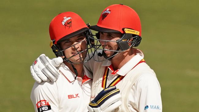 Alex Carey celebrates his century against Victoria with Tom Cooper. Picture: AAP Image/Scott Barbour