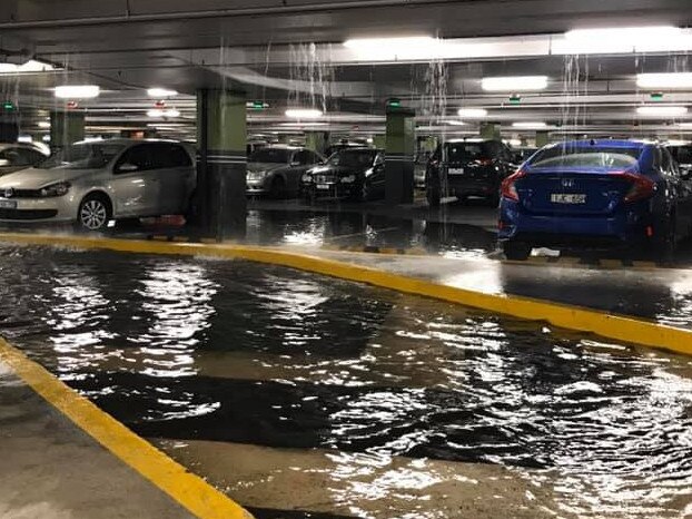 Inside the flooded carpark at Eastland, with water streaming through the building. Picture: Nadine Friend/Facebook.