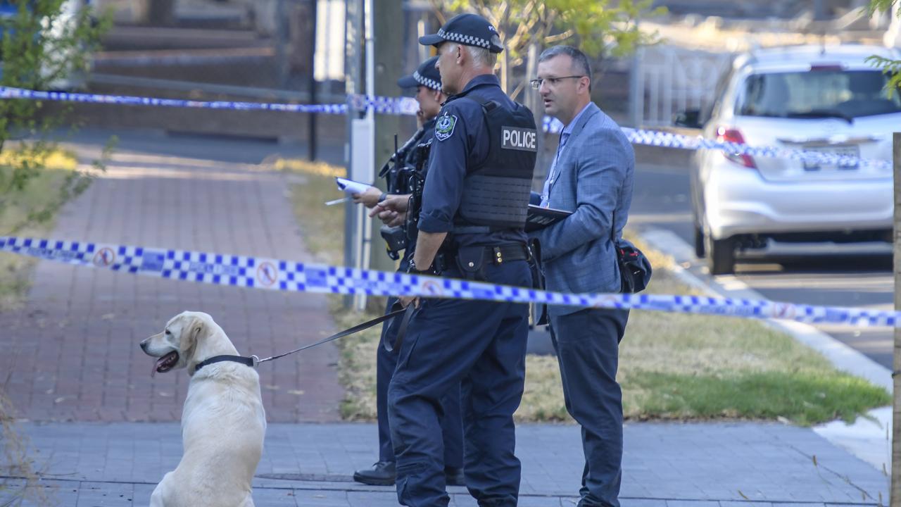 Police dog and detectives hunt for clues. Picture: RoyVPhotography