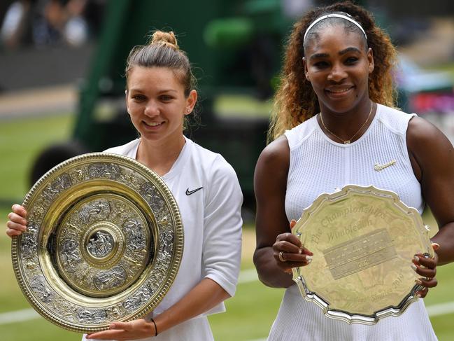 Simona Halep and Serena Williams pose with the spoils of their Wimbledon final battle.