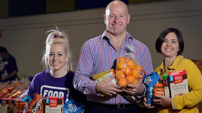 Foodbank AS chief executive Greg Pattinson with volunteers Laura Culbert (Foodbank) &amp; Tracey Noblet (Ikea) and some of the products on offer at the pop-up food store at Elizabeth Downs. Picture: Bianca De Marchi