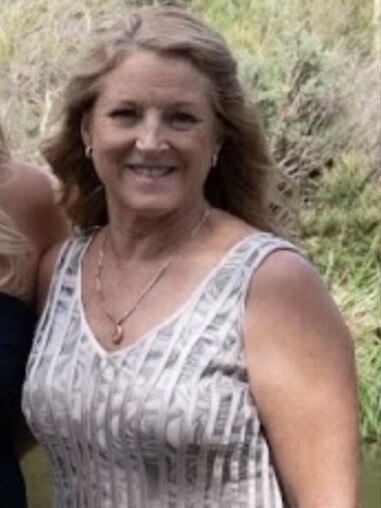 Torbanlea's Julie Stout, 61, died at the scene when a truck allegedly crossed to the wrong side of the Bruce Highway and collided with her four-wheel drive.