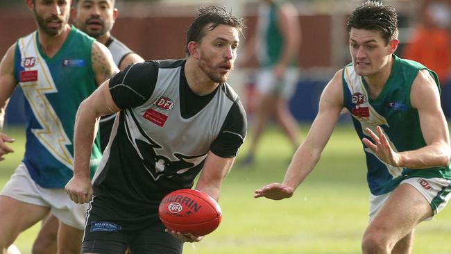 Michael Farrelly fires off a handball for Roxburgh Park. Picture: Hamish Blair