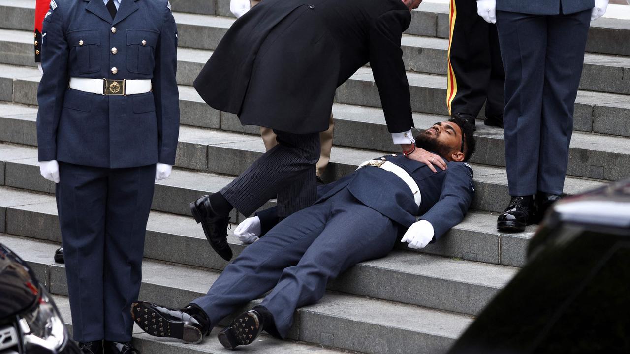A member of the military faints on the steps ahead of the National Service of thanksgiving for The Queen's reign at Saint Paul's Cathedral in London on June 3. Picture: Henry Nicholls/AFP