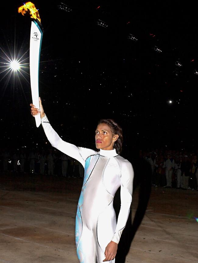 Cathy Freeman prepares to light the Olympic flame in Sydney in 2000. Picture: AFP