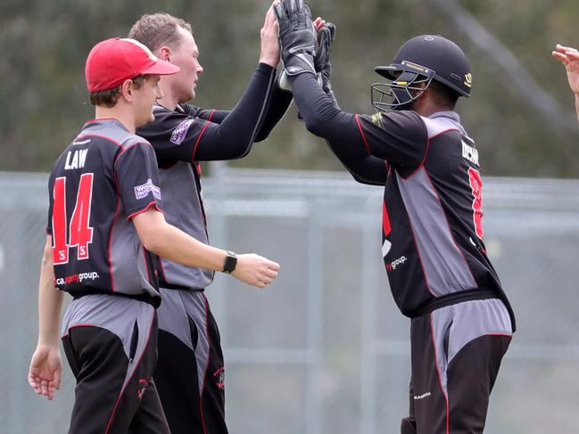 West Coburg players celebrate a wicket during a VTCA match this summer. 