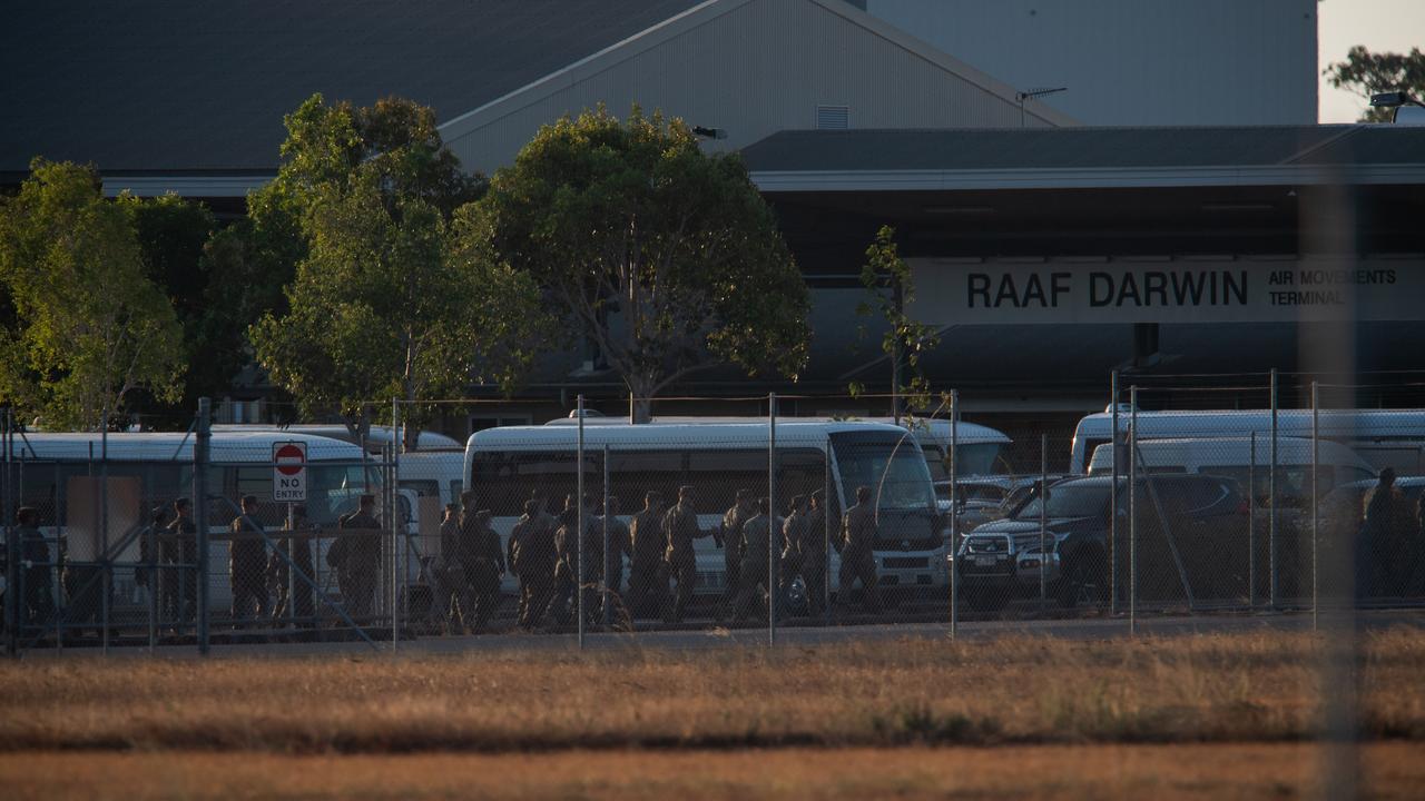 Troops await the arrival of fallen comrades at RAAF Darwin. Picture: Pema Tamang Pakhrin