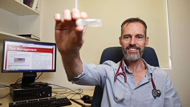 Dr Andy Ratchford in 2017 with one of the ticks removed from patients at Mona Vale Hospital Emergency Department. Picture: Adam Yip.