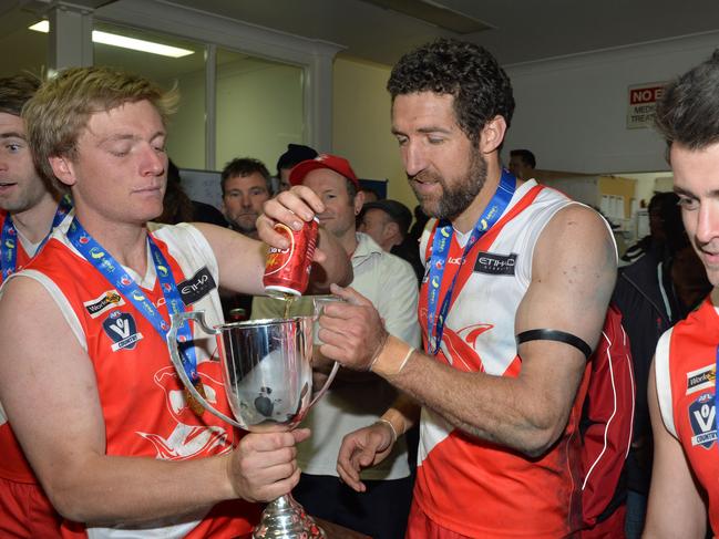 Nepean football league Grand Final: Sorrento v Frankston at Frankston Park. The Sharks went into the grand final as favourites and delivered another flag with a comfortable win over the Bombers. Aaron Paxton and Troy Schwarze fill the premiership cup.. Picture: AAP/ Chris Eastman