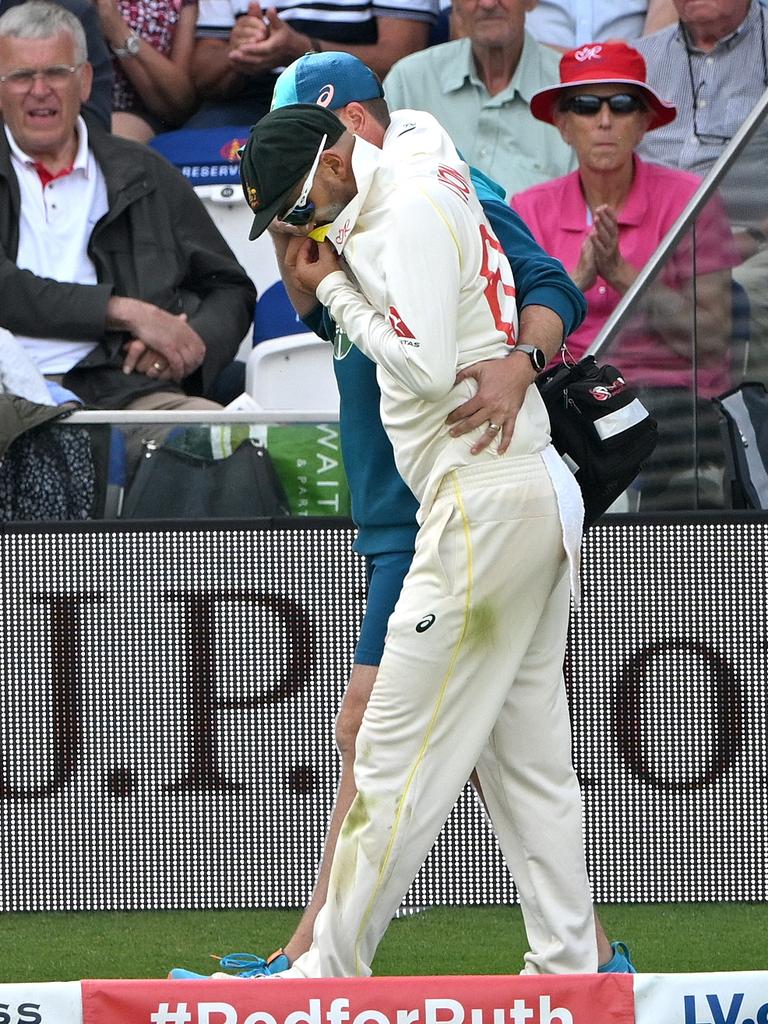 Nathan Lyon is helped around the boundary. Picture: Stu Forster/Getty Images