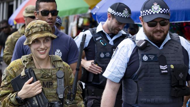 Australian Army Corporal Charley Gledhill from Joint Task Group 637.3 and Senior Constable Mike Niven from the Australian Federal Police contingent during a multi-agency policing patrol at the Port of Honiara, Solomon Islands.