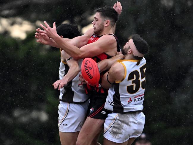 NFL: Panton Hill’s Nick Parks in a Thomastown sandwich. Picture: Andy Brownbill