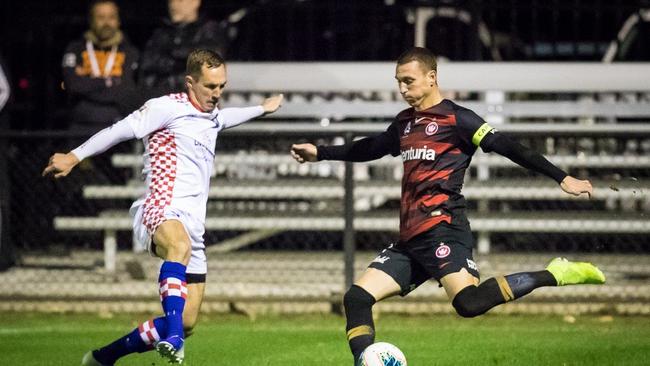 Matt Smith (left) battles with Western Sydney Wanderers attacker Mitch Duke in a trial last year. Picture: East End Digital.