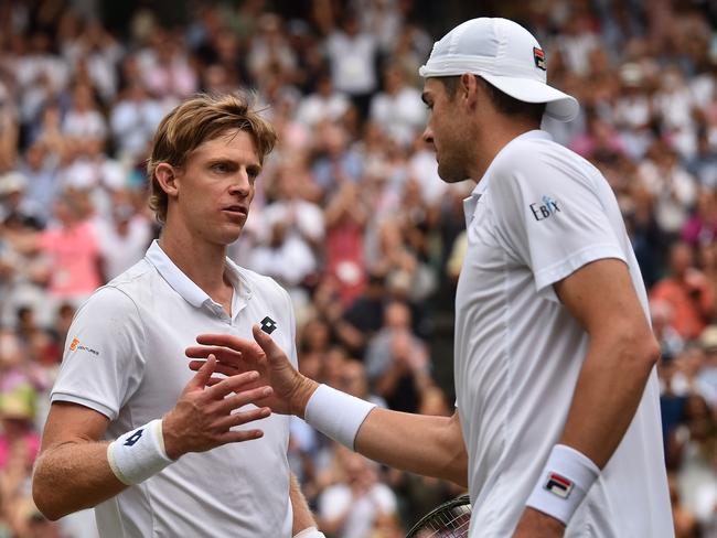 Kevin Anderson of South Africa, left, meets John Isner of the US after defeating him in their men's singles semifinal match at the Wimbledon Tennis Championships, in London, Friday July 13, 2018. (AP Photo/Glyn Kirk, Pool)