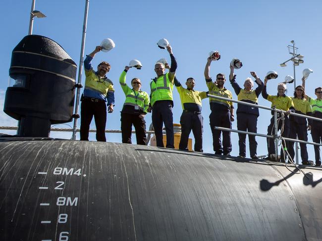 Embargoed until announcement approx 10:30am 26/4/2016 . Workers standing on HMAS Farncomb, docked at ASC's Osborne shipyard.