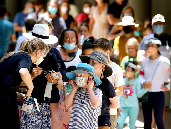 Children line up with their parents to get vaccinated at South Bank. Picture: David Clark