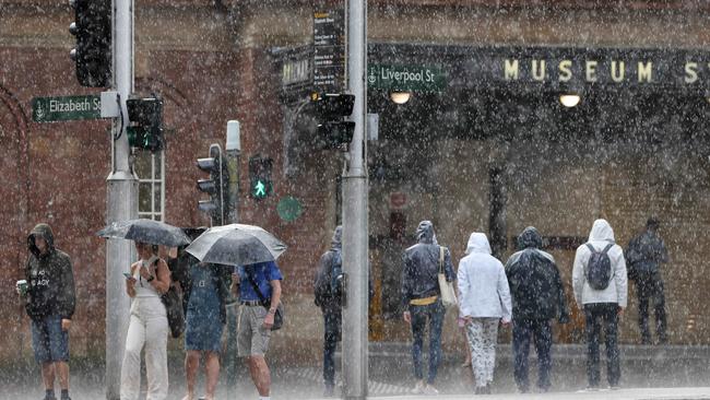 People battle the rain on Elizabeth Street in the Sydney CBD. Picture: NCA NewsWire / Damian Shaw