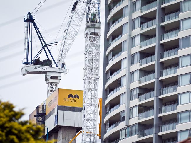 The Mirvac Group logo is displayed on a crane at the construction site of a residential apartment block, left, in Sydney, Australia, on Friday, Dec. 7, 2012. The Australian Bureau of Statistics is scheduled to release October home-loan approvals data on Dec. 10. Photographer: Ian Waldie/Bloomberg via Getty Images