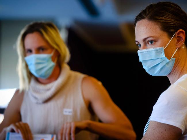 The Campbell sisters Bronte (left) and Cate recover after getting their COVID-19 vaccine injections. Picture: Patrick HAMILTON / AFP