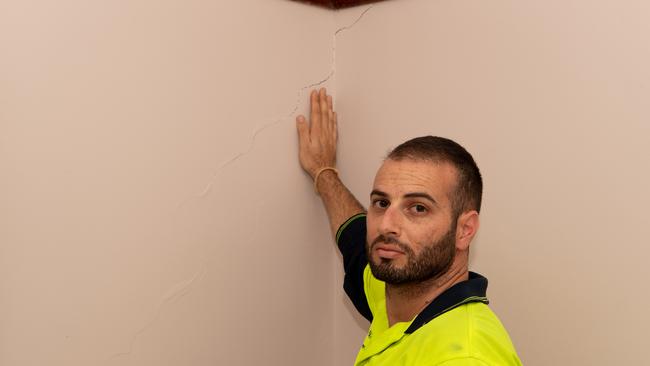 Patrick Borg inspects a crack in his house. Picture: Monique Harmer