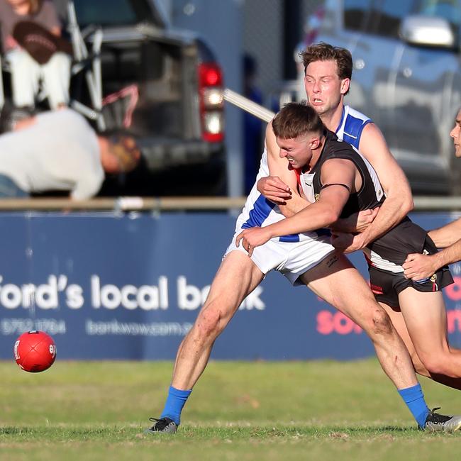 Myrtleford’s Diesel Batey is held up in a tackle without the ball.