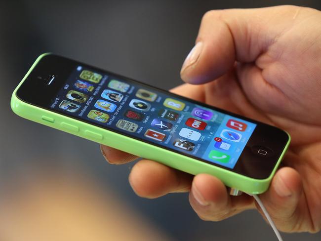 BERLIN, GERMANY - SEPTEMBER 20: A customer tries out the new Apple iPhone 5C smartphone at the Berlin Apple Store on the first day of sales on September 20, 2013 in Berlin, Germany. The new iPhone 5S and 5C phones went on sale all over the world today and hundreds of customers waited outside the Berlin store in the rain to be among the first to buy the new phones starting at 8am. (Photo by Sean Gallup/Getty Images)