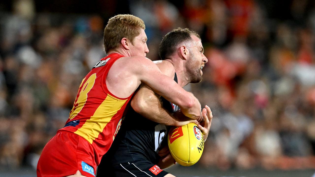 Sam Docherty is pressured by Matt Rowell. Picture: Getty Images