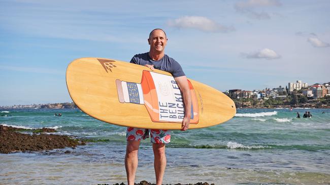 Larry Emdur at North Bondi Beach with a surfboard with his whisky brand on it, The Ben Buckler. Picture: Tim Hunter
